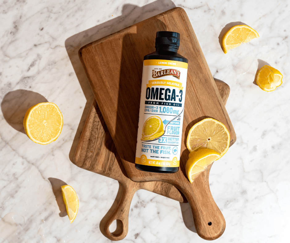The Science Behind Omega-3s & Heart Health, Barlean's Omega-3 oil bottle with lemons on wooden cutting boards.
