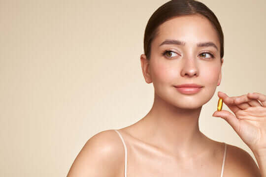 a woman applying skincare out of the shower to complement the Benefits of Fish Oil for Skin health