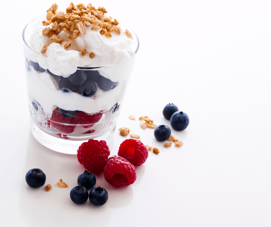 breakfast yogurt parfait cup with fresh fruit and granola on top