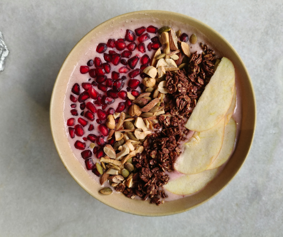 Tropical smoothie bowl topped with coconut and fruit