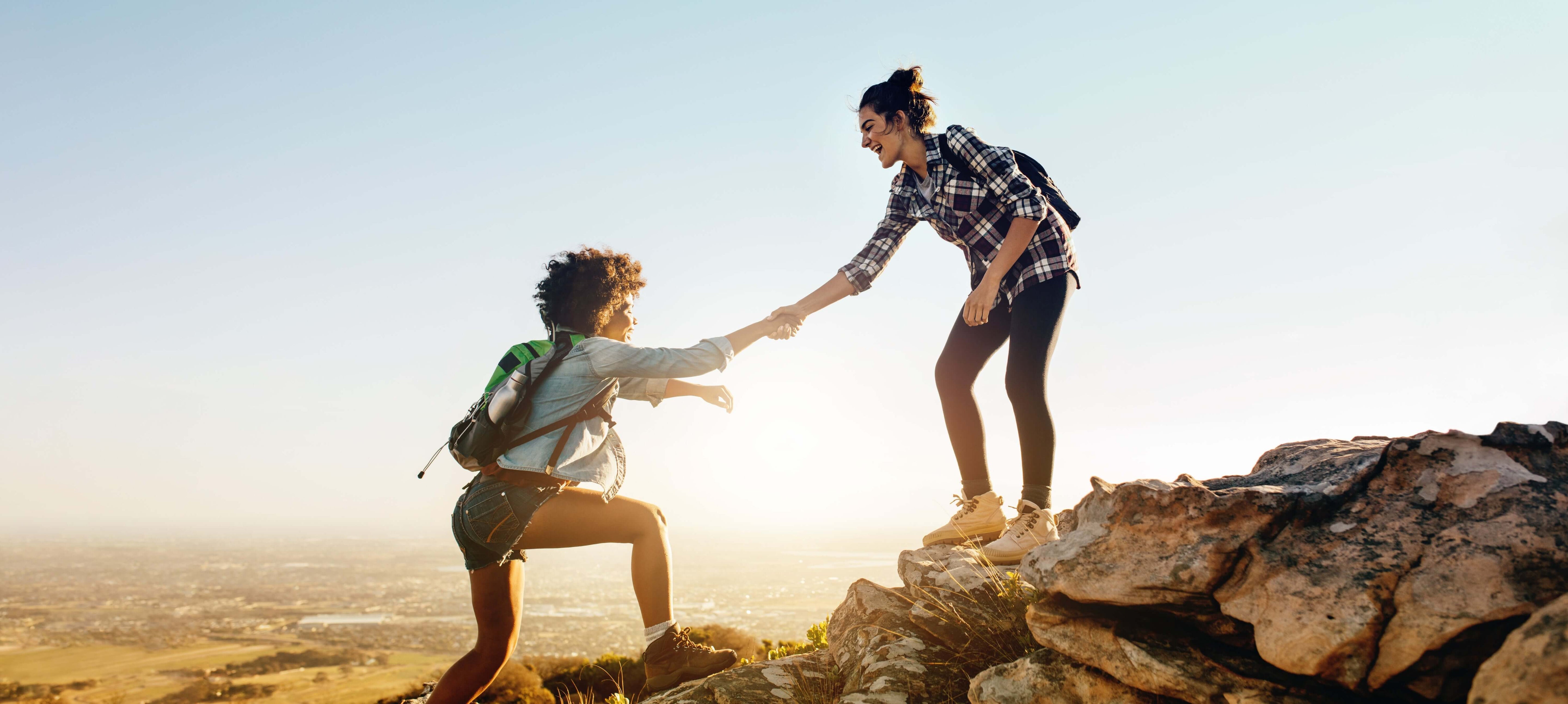 two women hiking a mountain