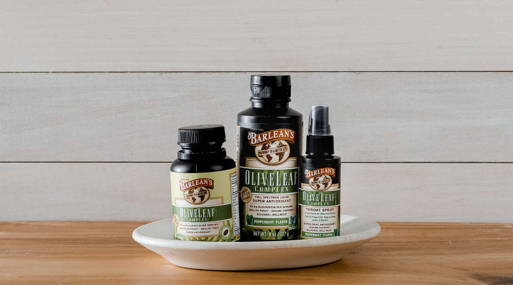 Image: Barlean's Olive Leaf extract soft gels, liquid and throat spray sitting on plate