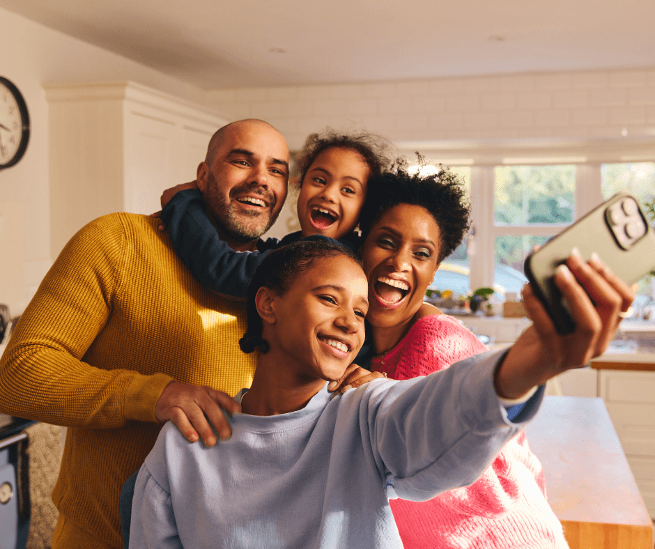 a family in their home taking a selfie together
