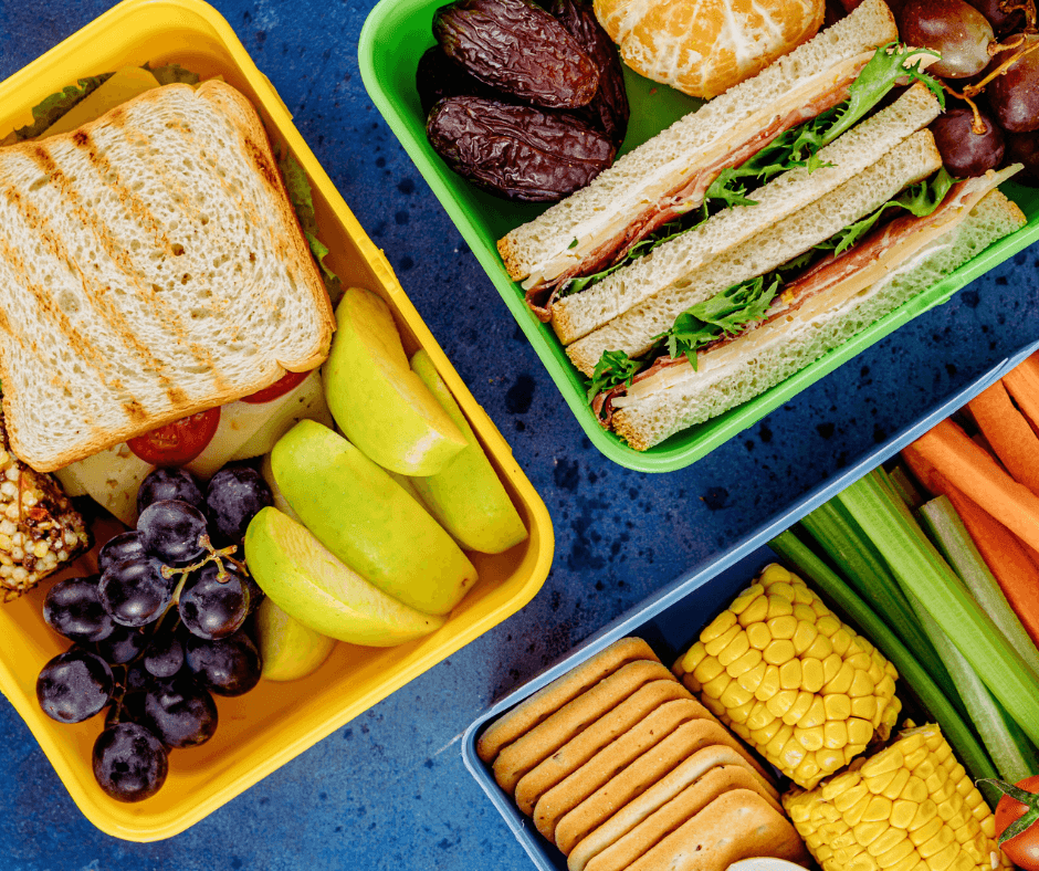 packed school lunches with sandwiches, grapes, fruit, and crackers