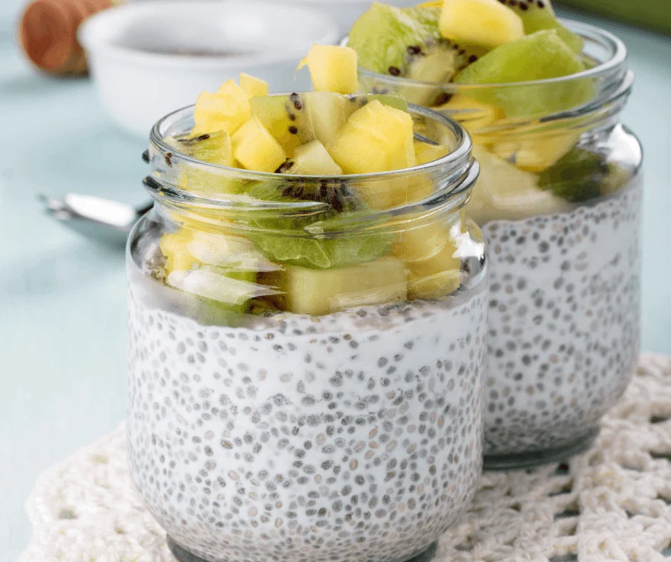 Tropical Chia Pudding with Pineapple & Lime topped with fresh kiwi and pineapple in glass jars.
