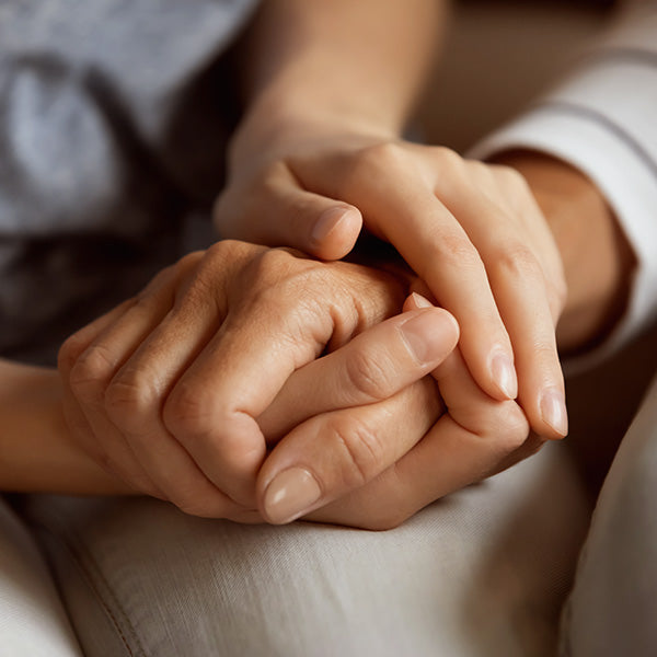 2 people holding each others hands.