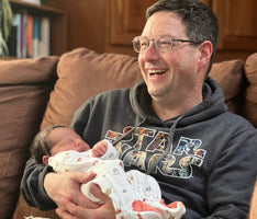 A Barlean's employee holding his grandchild.
