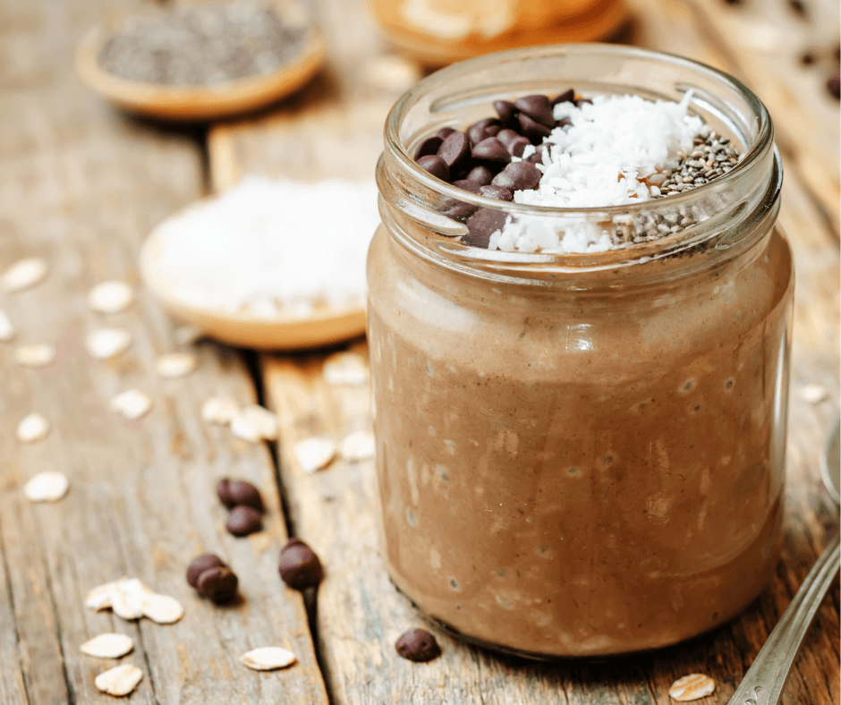 a mason jar full of overnight oats with chocolate and bananas around it