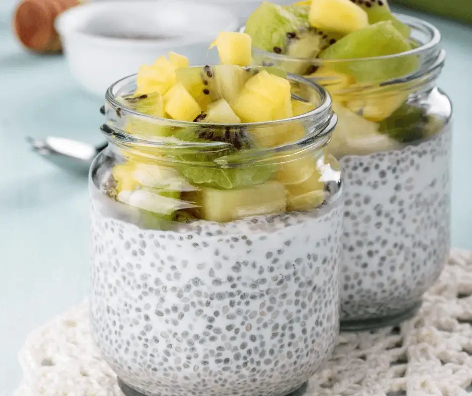 Tropical Chia Pudding with Pineapple & Lime topped with fresh kiwi and pineapple in glass jars.