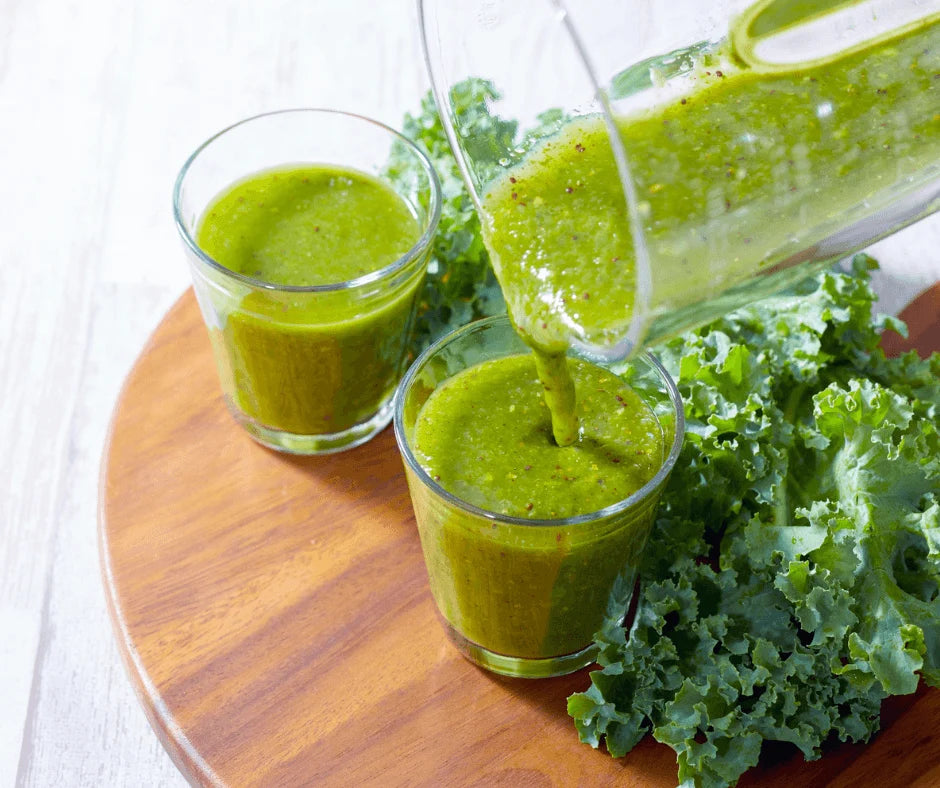 Tropical Green Smoothie for a Summer Energy Boost in clear glasses with fresh kale.