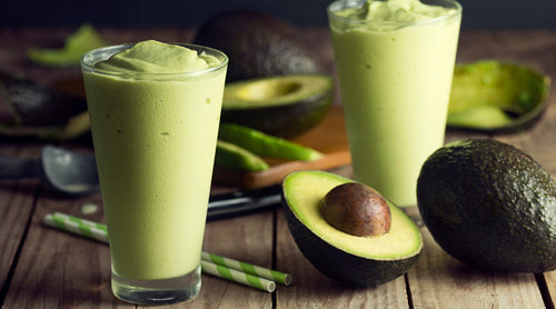 Image: Avocado smoothie on table with cut avocados