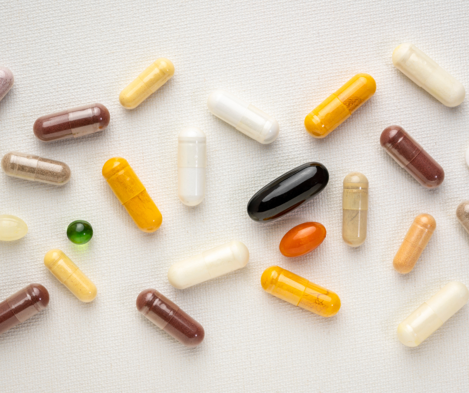 Multivitamins: Do You Really Need Them? Various dietary supplements in capsule form scattered on a surface.