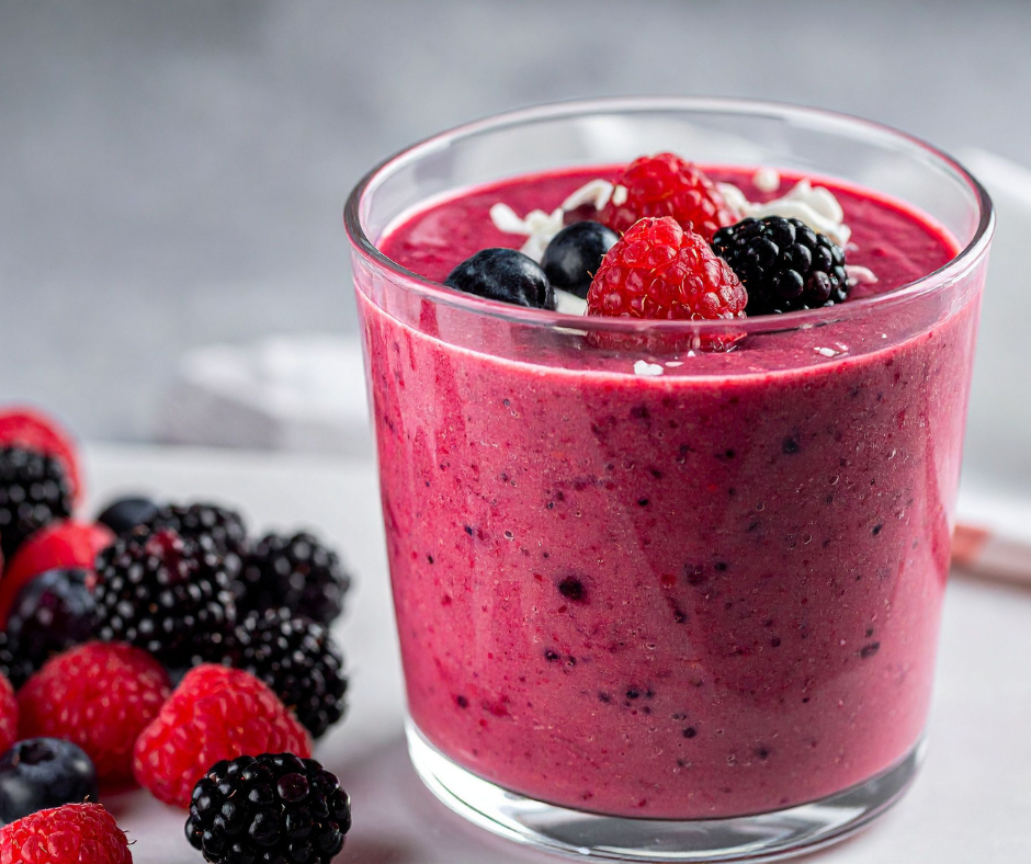 Heart-Healthy Berry Smoothie with Flax Oil topped with fresh berries in a clear glass.