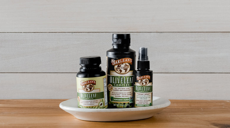 Image: Barlean's Olive Leaf Complex soft gels, liquid and throat spray sitting on plate