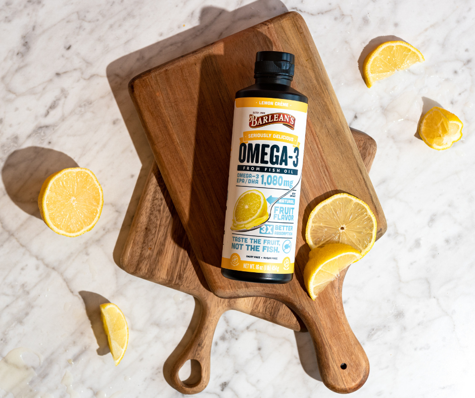 The Science Behind Omega-3s & Heart Health, Barlean's Omega-3 oil bottle with lemons on wooden cutting boards.