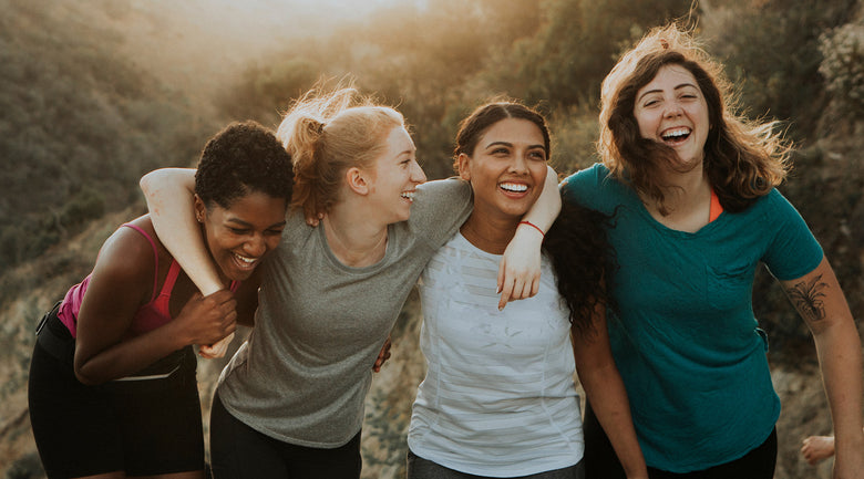Image: Group of women laughing and smiling on a hike