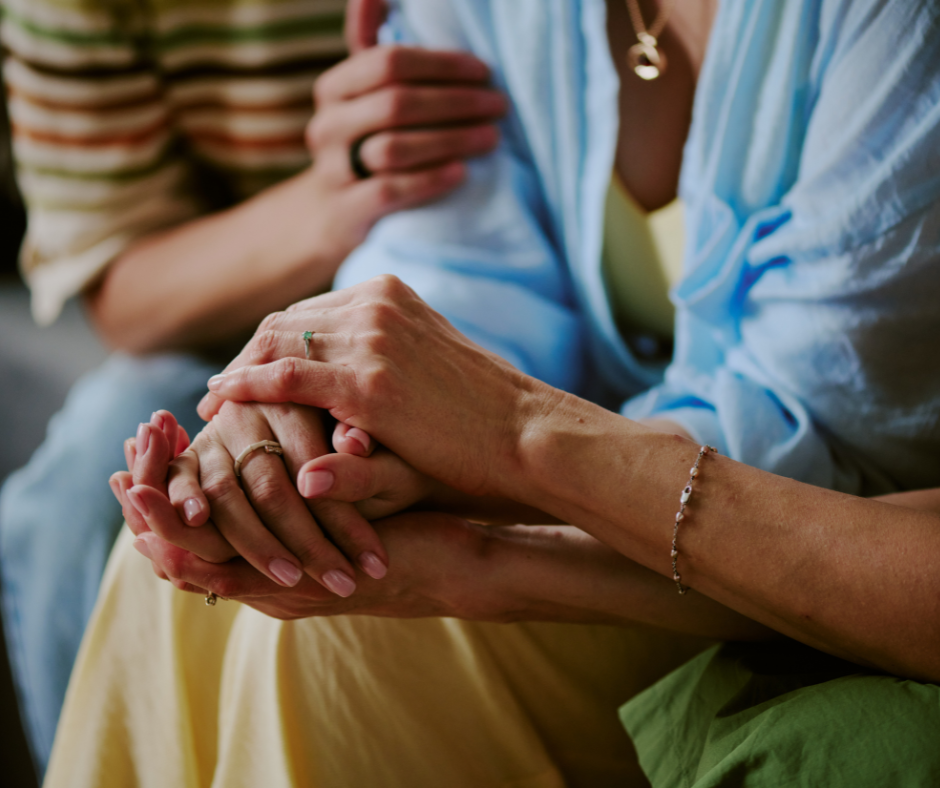 Women Supporting Women: 8 Small Ways to Show Up - Hands together symbolizing support and connection.