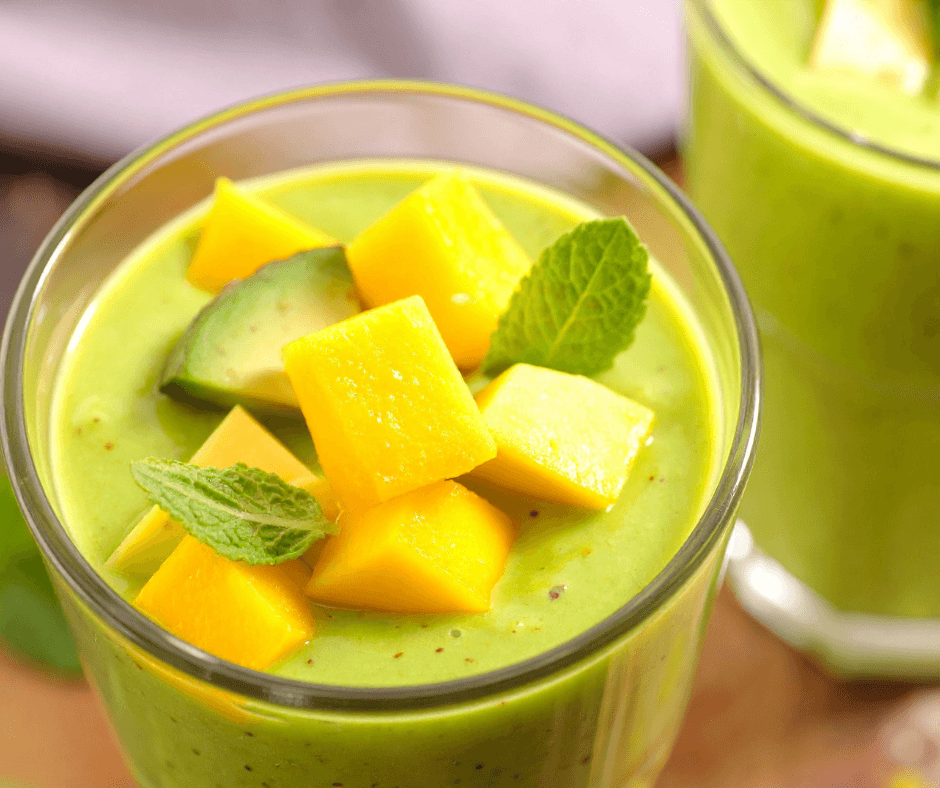 a citrus mango greens smoothie bowl with fresh mango on top