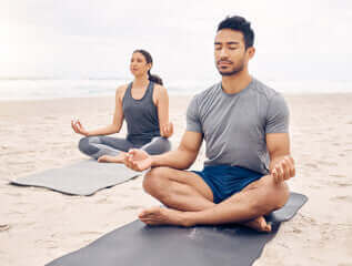 a man meditating on the beach as A Holistic Approach to Mental Health