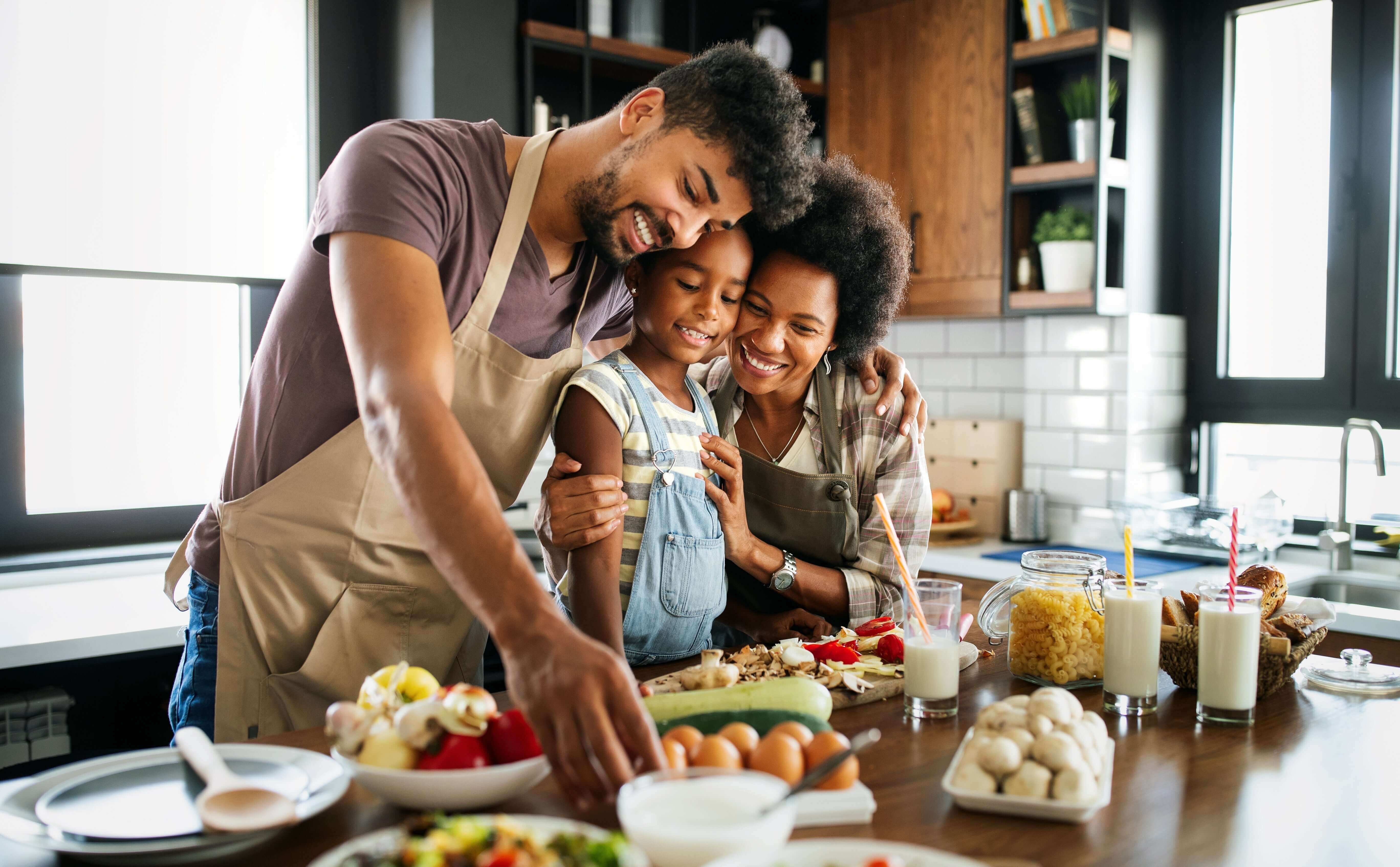 happy family embracing inside their home: How to Support Your Child's Vision and Brain Development blog