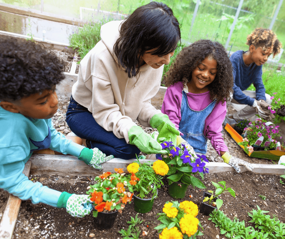 creating a family wellness routine with a mom and her 3 kids outside in the garden planting flowers in a garden bed