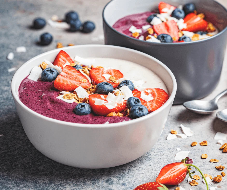 Berry Omega Smoothie Bowl for Busy Mornings topped with strawberries, blueberries, and granola in a white bowl.