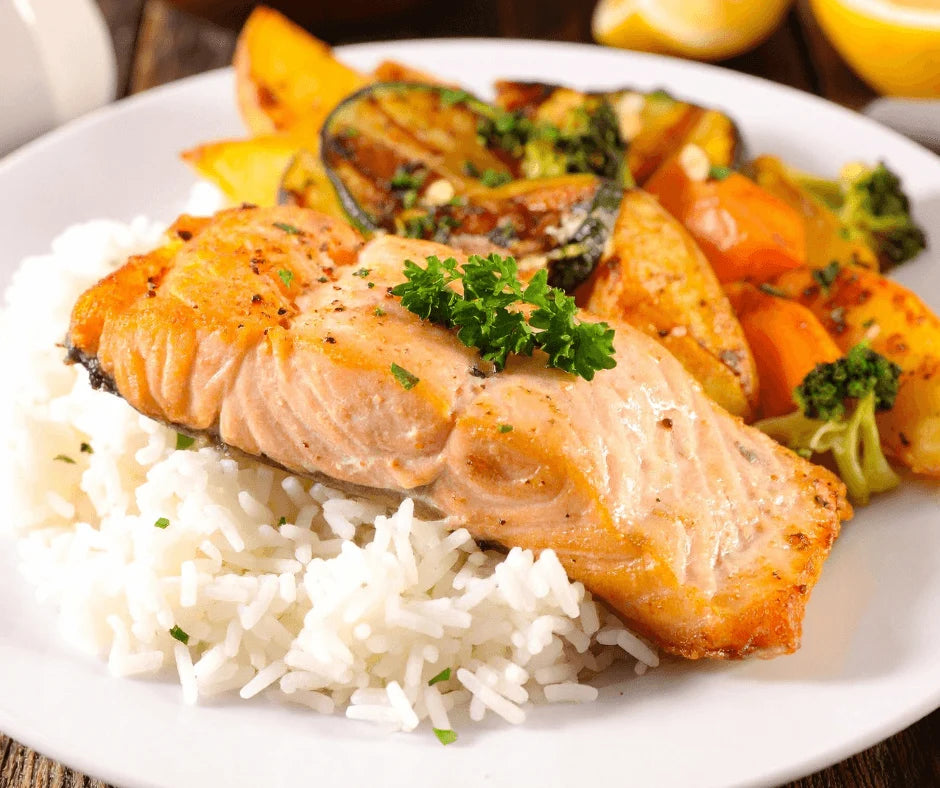 Citrus-Grilled Salmon with Fresh Herb Drizzle served on rice with roasted vegetables.