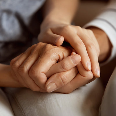 2 people holding each others hands.