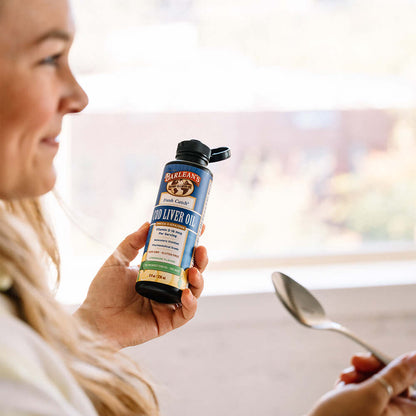 Cod liver oil supplement with citrus taste in a spoon